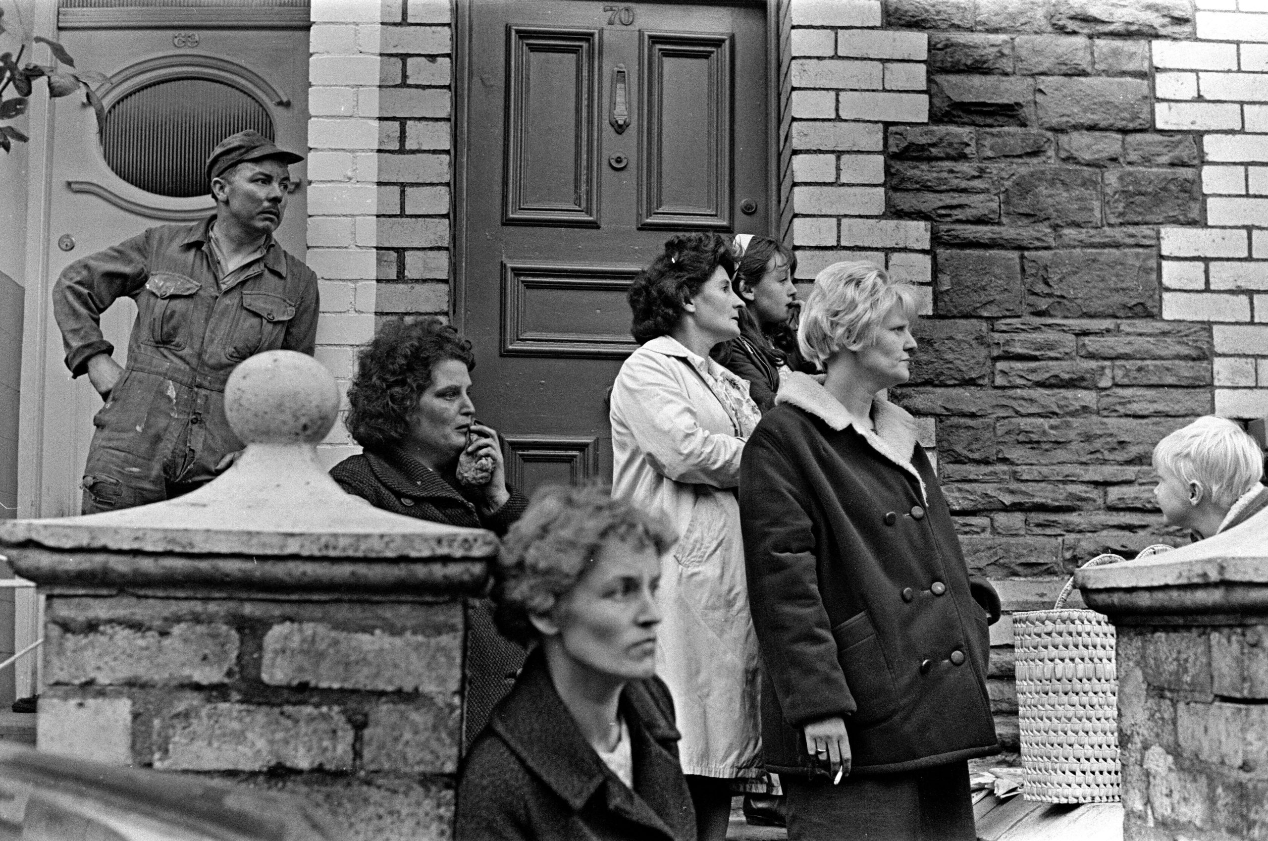 Aberfan, South Wales, circa 21st October 1966Picture shows shocked on lookers, looking towards the school and the the mud and devastation caused when mining spoil from the hillside high above the town behind came down  and engulfed The Pantglas Junior Sc